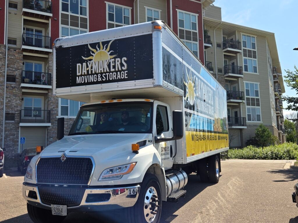 Daymakers Moving & Storage truck parked outside an apartment building